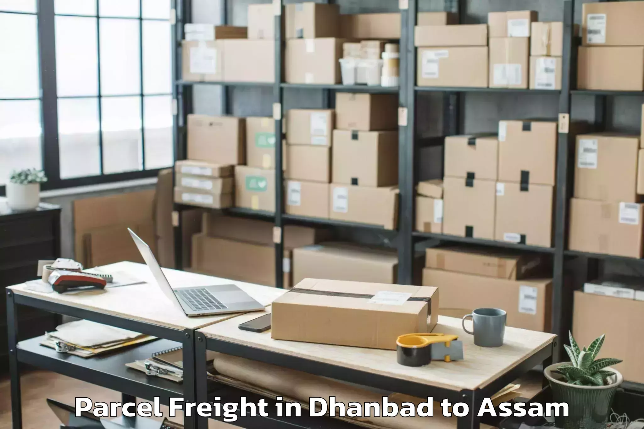 Book Your Dhanbad to Numaligarh Parcel Freight Today